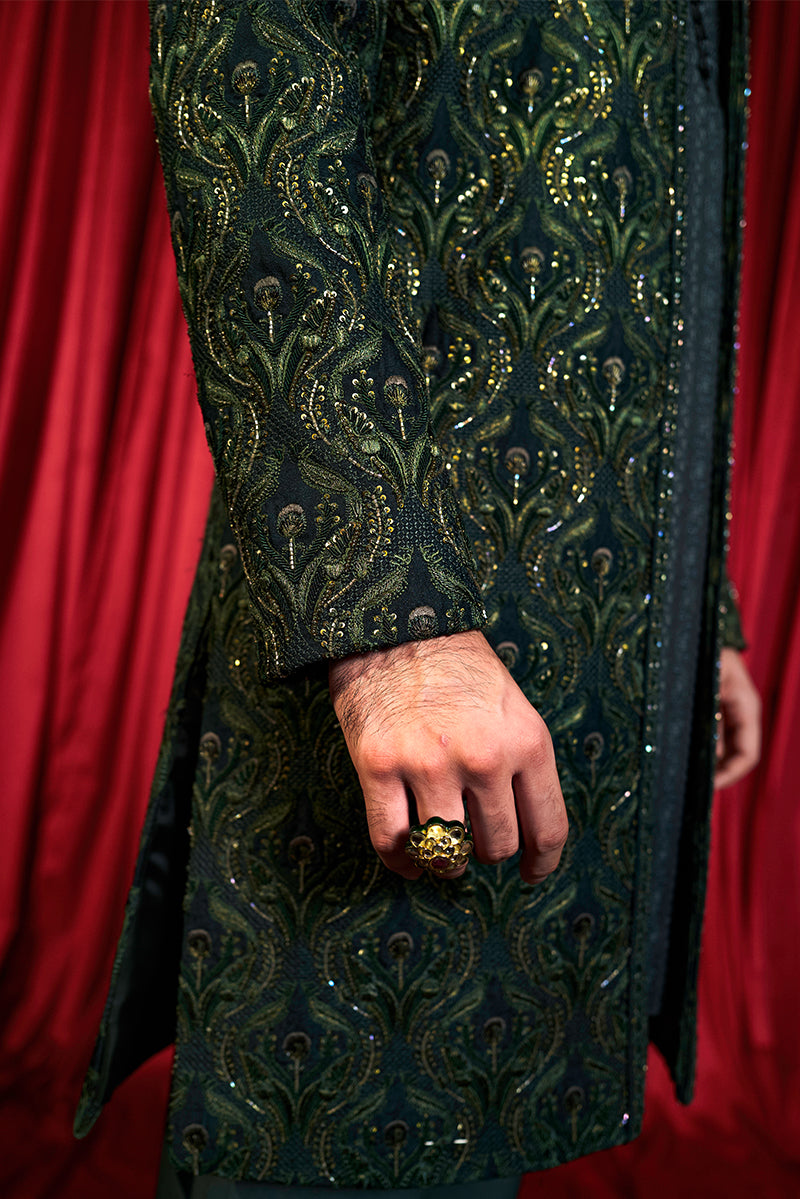Shop designer embroidered green sherwani for groom with intricate gold detailing, available for online purchase. Perfect traditional attire for weddings and special occasions.