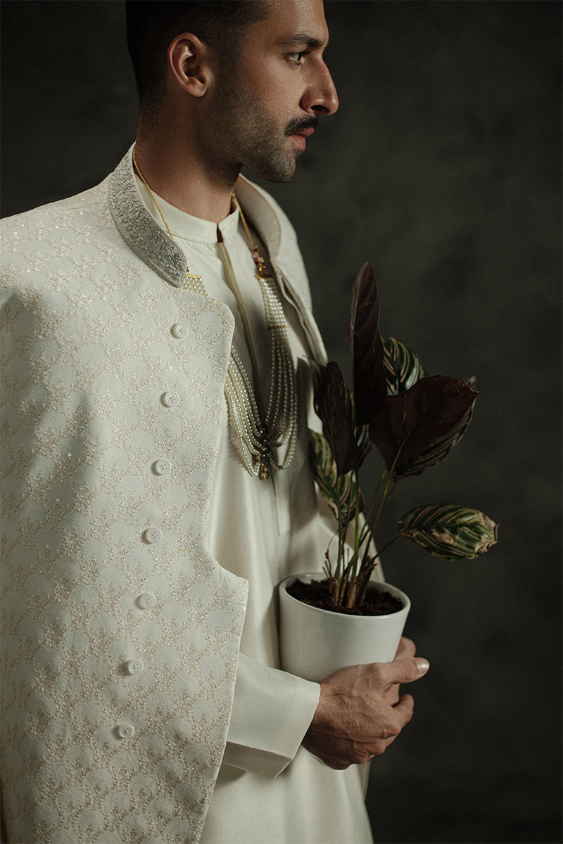 Classic groom sherwani in white with royal embroidery