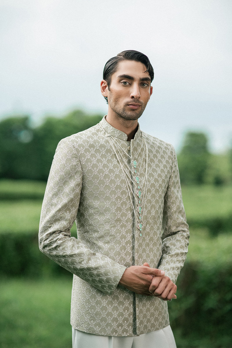 Stylish prince coat for groom in a vibrant green color, crafted for modern wedding fashion.
