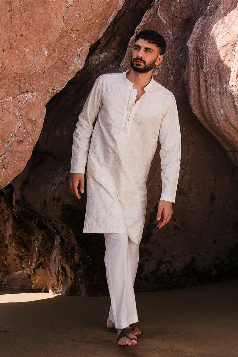 Back view of the ivory white embroidered kurta pajama showing its stylish back design.