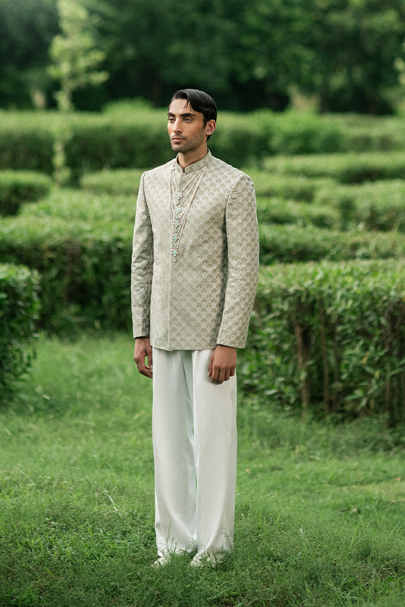 Modern green prince coat with detailed embroidery, designed for the groom's big day.