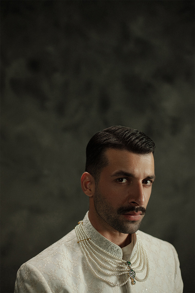 Royal white sherwani for grooms with luxurious embroidery.